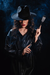 Sexy female dominant mistress with a whip flogger for BDSM sex with submission and domination