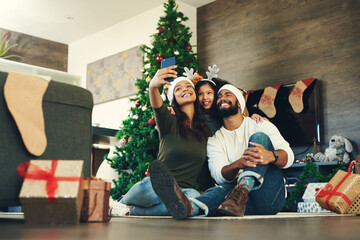 Family, selfie and celebrating christmas with a man, woman and child excited in a family photo for...