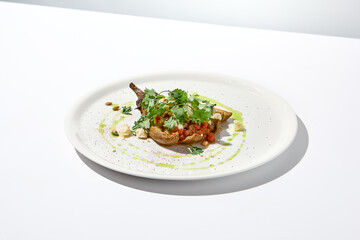 Baked eggplant with cheese on white table with harsh shadows. Aesthetic italian food - baked...
