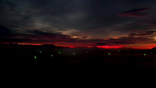 Pentai Tengah Beach in Langkawi, Malaysia. Timelapse of sunset and flight path orientation lights. 