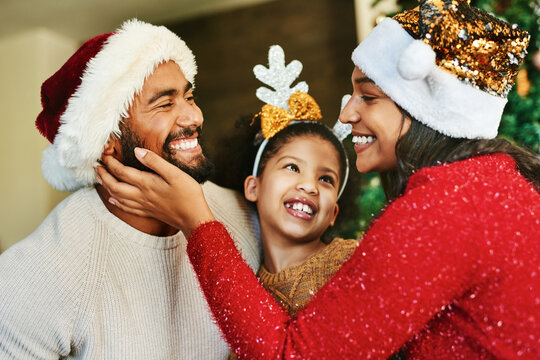 Family, Christmas Celebration And Love With Happy Smile And Festive Holiday, Care. And Decoration With Hat In Home. Mother, Father And Girl Together In House To Celebrate Xmas Event In Family Home