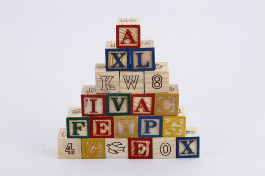 Child's toy wooden blocks stacked in a triangle