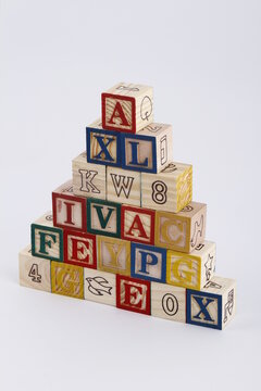 Child's toy wooden blocks stacked in a triangle