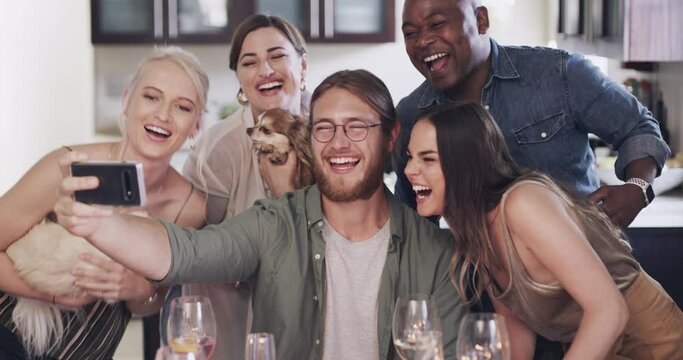 Friends, phone selfie and funny face at dinner party, diversity and dog with social media, picture and happy smile together. People, photo and mobile smartphone in home, happiness and crazy with pet