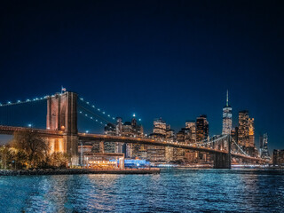 Fototapeta na wymiar Brooklyn Bridge, Evening lights, Reflections, Skyline