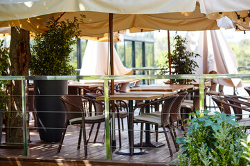 Restaurant terrace umbrella with light lamp bulbs. Modern exterior of summer cafe. Blurred image, selective focus