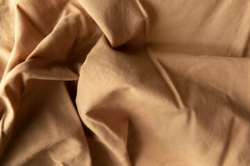 Comfortable creased linen or cotton cloth beige or light brown color made of environmental eco friendly natural material texture design use for fashion background with space