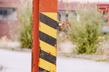 road obstacle painted with paint, informing about the danger in the industrial zone