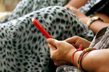 Hand of Indian woman using mobile phone