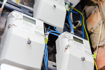 A domestic electric smart meter.Green LCD display.Concept for energy bills, price rise, inflation,...