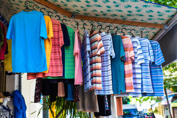 Many colorful t-shirts hanging in the vietnamese market in Nha Trang