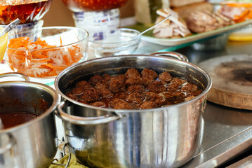 meatballs in asian sauce in a pot on street food in Vietnam