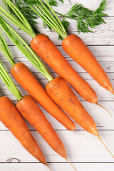 Fresh carrots on rustic wooden  background. 