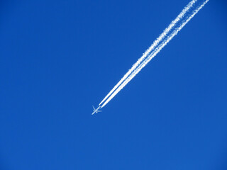 Unusual plane tracks in the blue autumn Swiss sky or conspiracy theory - chemtrails in our heaven...