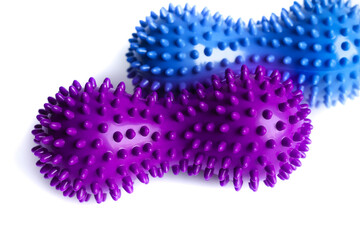 Blue and purple double or peanut spikey balls massager for yoga pilates or stretching and fascia pain. Sports equipment for fitness isolated on a white background. Concept of sports massage. 