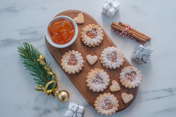 sweet home made linzer christmas cookies filled with apricot jam on a table