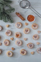 sweet home made linzer christmas cookies filled with apricot jam on a table