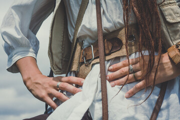 Close up courageous woman with arms akimbo concept photo. Pirate girl with dreads. Front view...