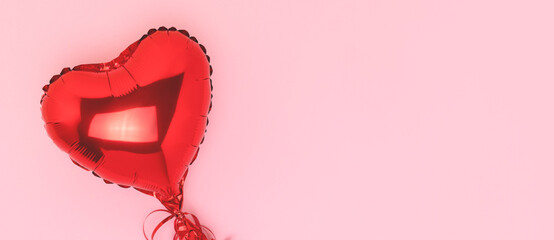 Banner with red inflatable foil balloon in a heart shape. Minimal composition on a pink background...
