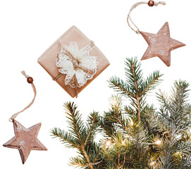 Neutral Christmas composition of fir branches, wooden stars of baubles and gift in paper packaging. Zero Waste Christmas