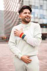 portrait of young hispanic man with lgbt bracelet