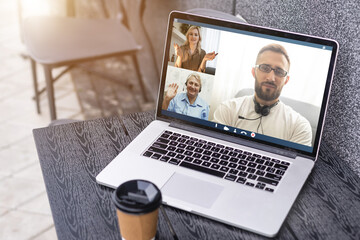 Man Working From Home Having Online Group Videoconference On Laptop