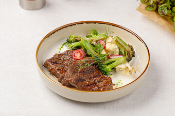 Portion of gourmet beef steak with vegetable salad