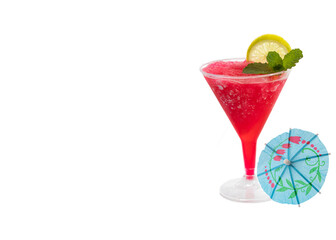 A red delicious summer slushie cocktails garnished with a slice of lime and a sprig of mint leaves viewed isolated on white background.