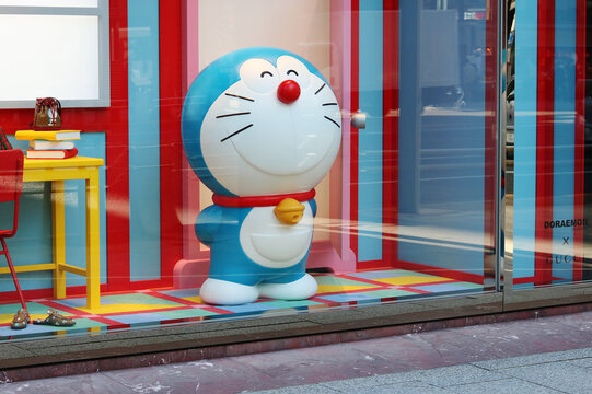 TOKYO, JAPAN - February 3, 2021: Gucci store window display in Tokyo's Ginza area featuring the character Doraemon and related products. 
