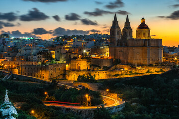 Fototapeta na wymiar Il-Mellieha, Malta - Beautiful panoramic skyline view of Mellieha town after sunset with Paris Church