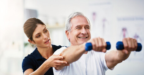 Fototapeta na wymiar Physiotherapy, senior man and dumbbell exercise, injury rehabilitation or workout at health clinic. Happy elderly patient, woman physiotherapist or muscle training for strong body, care or fitness