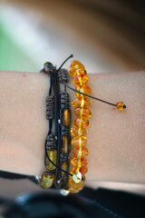 Beautiful amber bracelet on female hand. Close up.