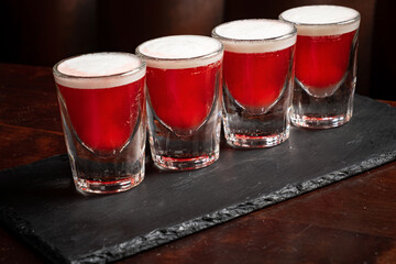 shots with vodka on wooden background