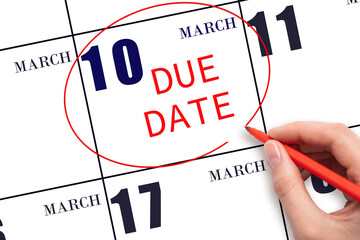 Hand writing text DUE DATE on calendar date March 10 and circling it. Payment due date