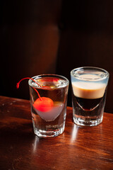 shots with vodka on wooden background