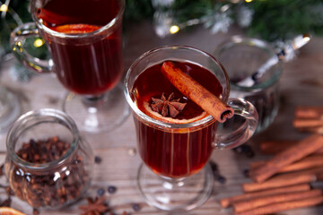 Christmas mood, holiday atmosphere. Mulled wine in glassware on a wooden table.