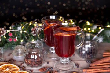 Christmas mood, holiday atmosphere. Mulled wine in glassware on a wooden table.