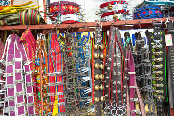 Various dog collars for sale hang in front of the shop.