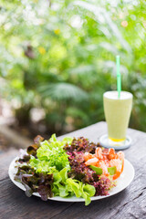 Healthy Food fresh salad and vegetable juices on wood table. 