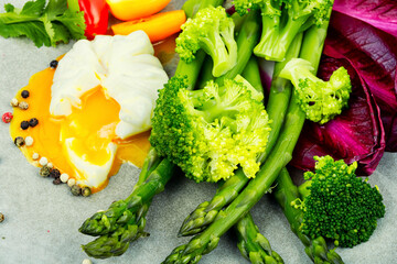 Healthy salad of asparagus, lettuce and poached eggs.