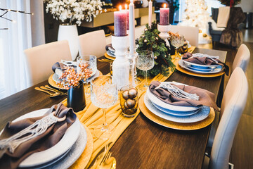 Christmas Eve table decorations, Christmas mood, Christmas tree on the dining table. Defocused