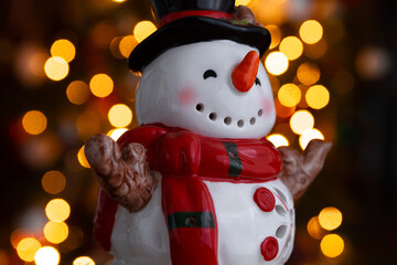 Ceramic snowman figurine. Beautiful, festive toy decoration for Christmas and winter, with tree...