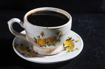 cup of javanese coffee isolated on a black background