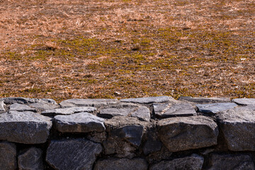 a stone wall on the lawn