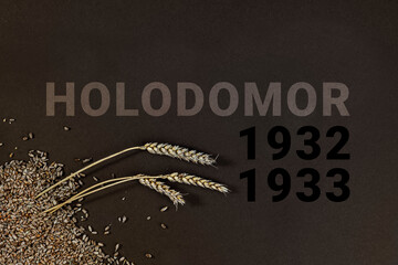 Grain and three spikelets on a black background. Symbol of the tragedy genocide of the Ukrainian...