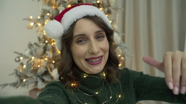 woman calls her friends via video conference call wishing Merry Christmas