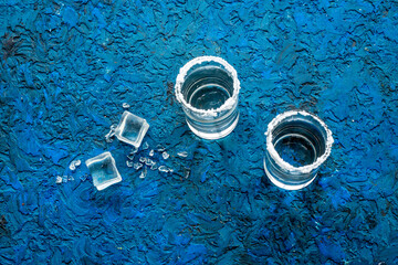 Strong alcohol background - glasses of tequila with salt