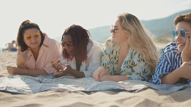 Cinematic storytelling footage of beautiful plus size women having fun at the beach in the summertime. Oversized big girls friends, representation of body positivity and body acceptance concepts