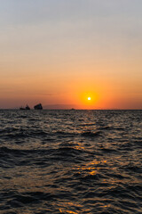 Sunset landscape with the silhouette of ships and mountains in the background in the port of Izmir, Turkey.