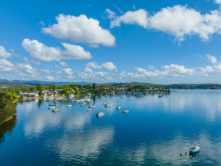 Morning waterfront views with clouds, boats and the blue lake water.